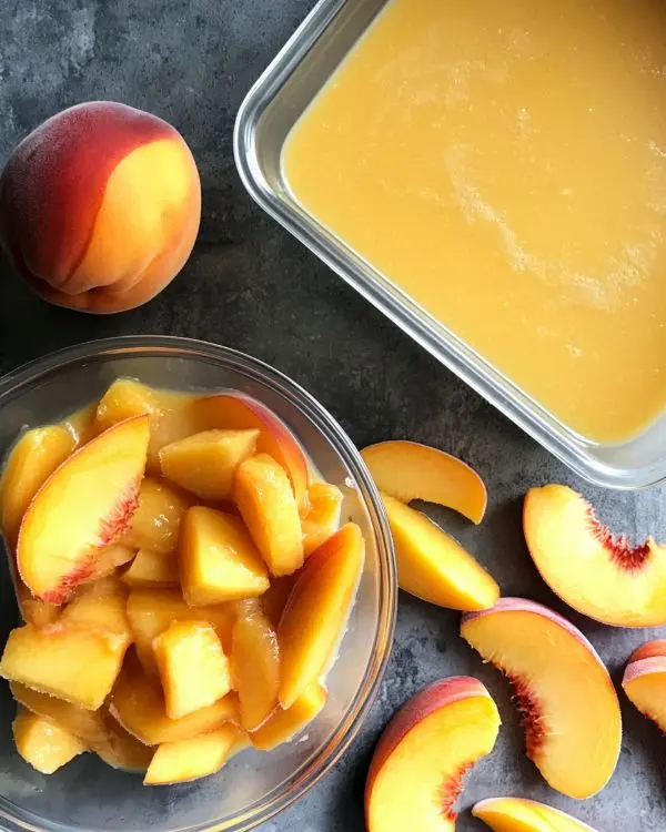 Freezing Peaches 4 Freezing Peaches slices in clear storage container next to smoothie bowl using frozen peaches