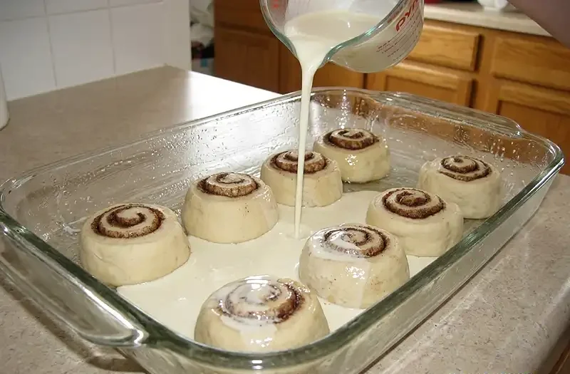 cinnamon roll bake with heavy cream​ in the just‑sprayed dish